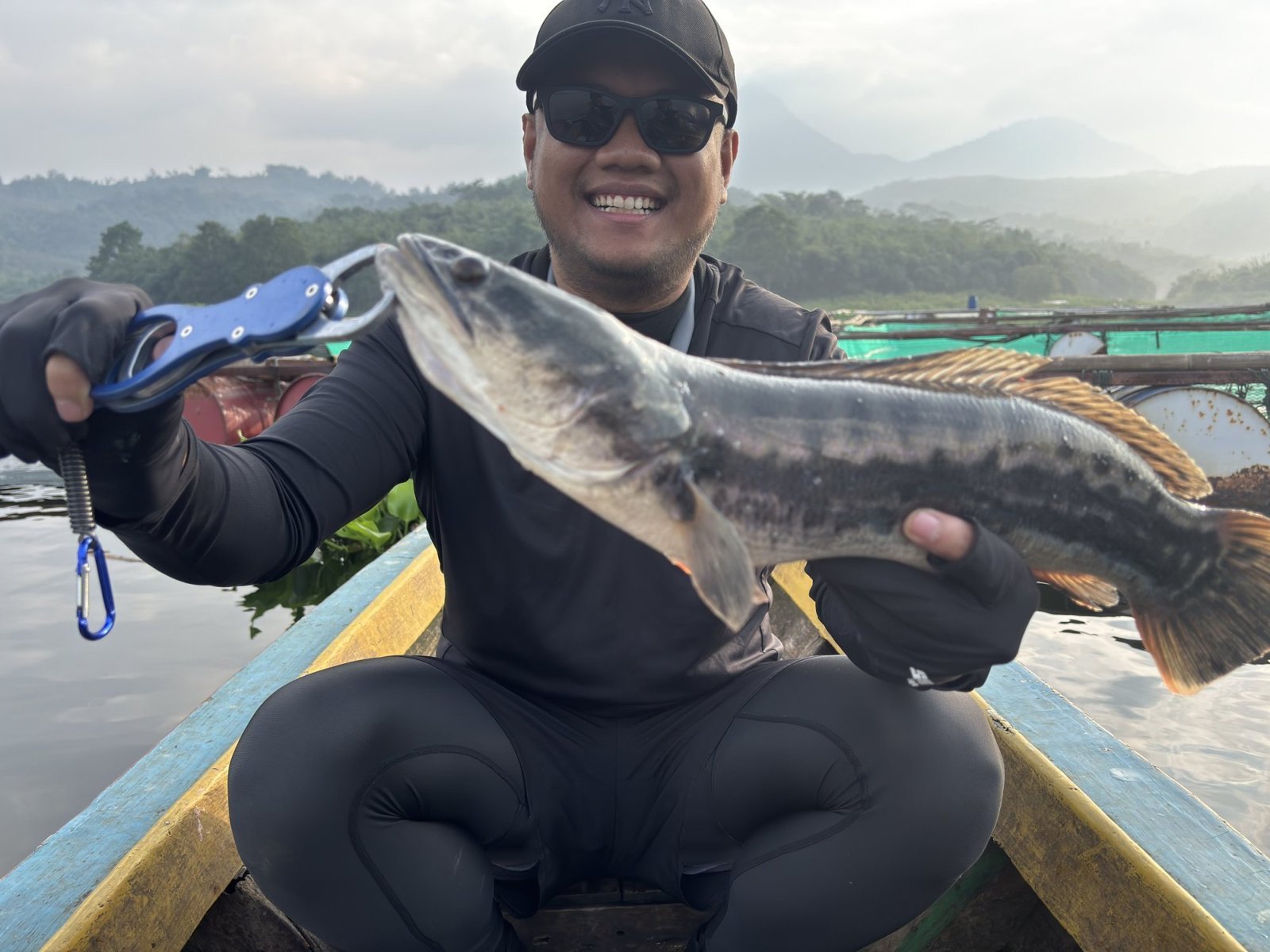 Angler mengangkat toman hasil casting di Waduk Jatiluhur